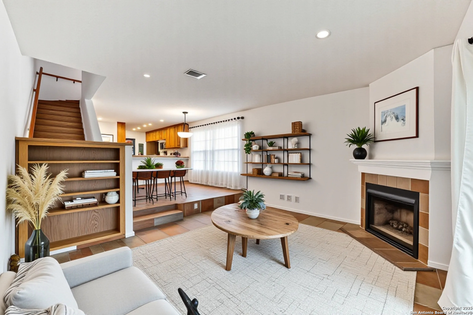 a living room with furniture and a fireplace