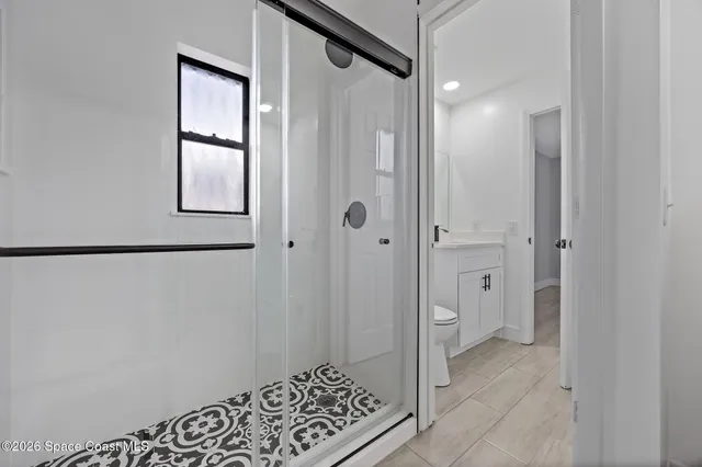 a bathroom with a shower and a sink