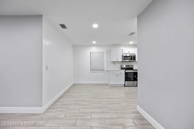 a view of a kitchen with a sink and cabinets