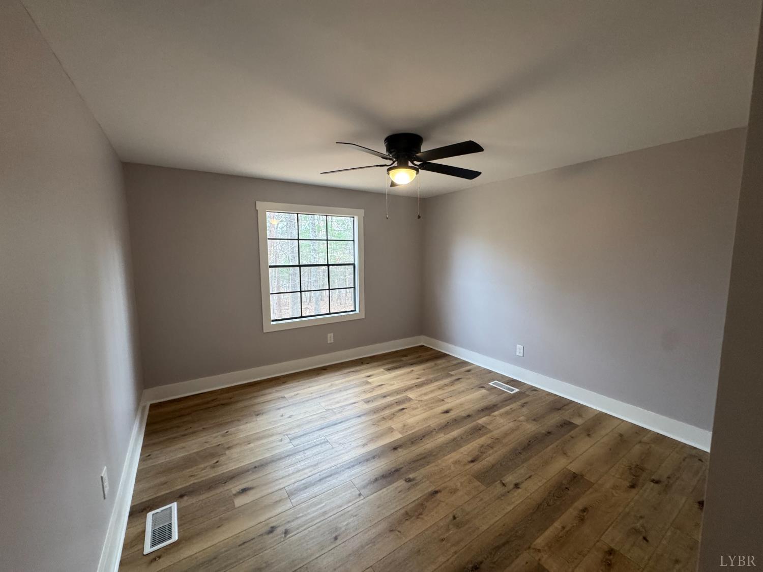 137 Ridgeview Lane Madison Heights, VA 24572 - Photo 11 of 22 an empty room with wooden floor and windows
