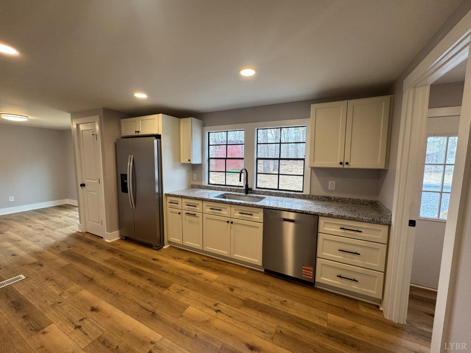 137 Ridgeview Lane Madison Heights, VA 24572 - Photo 5 of 22 a kitchen with granite countertop a refrigerator and white cabinets