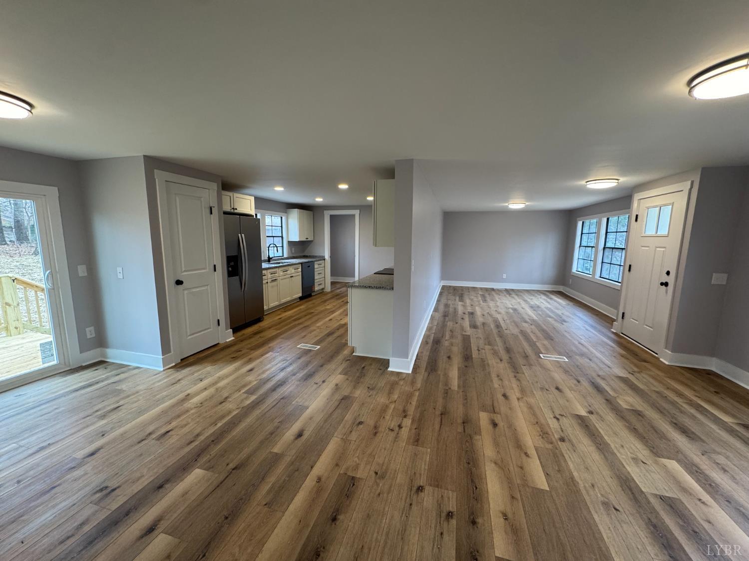 137 Ridgeview Lane Madison Heights, VA 24572 - Photo 8 of 22 a view of a big room with wooden floor and windows