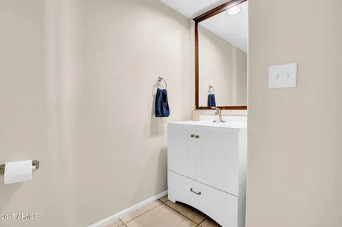 a kitchen with stainless steel appliances kitchen island granite countertop a refrigerator a stove a oven with white cabinets and island