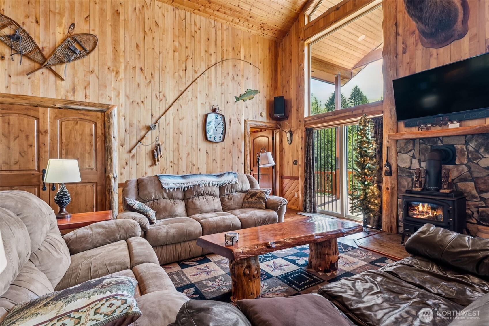 0 Boyd Road Randle, WA 98377 - Photo 7 of 39 a living room with furniture a flat screen tv and a floor to ceiling window