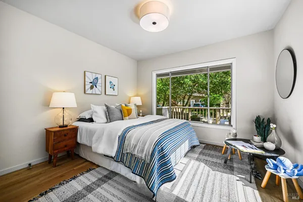 a spacious bedroom with a bed a couch and a window