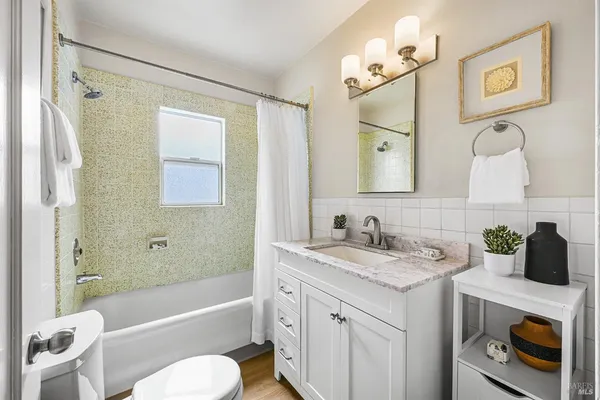 a kitchen with stainless steel appliances granite countertop white cabinets and a stove a oven with white countertops