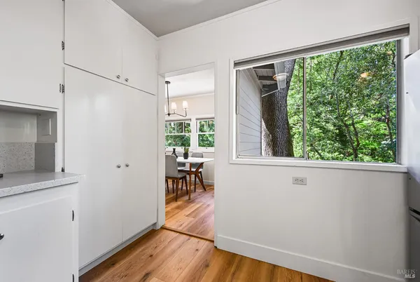 a spacious bedroom with a bed and glass window