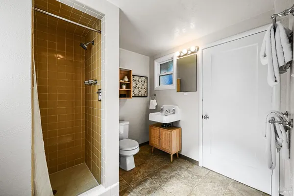 a kitchen with a table chairs and white cabinets