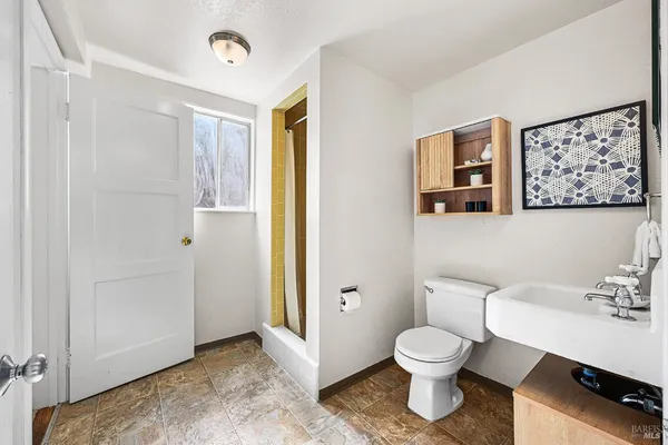 a kitchen with stainless steel appliances a stove a table chairs and a refrigerator