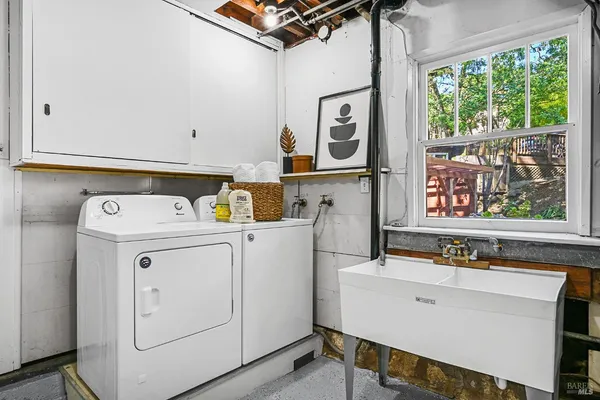 a view of a patio with couches table and chairs and potted plants