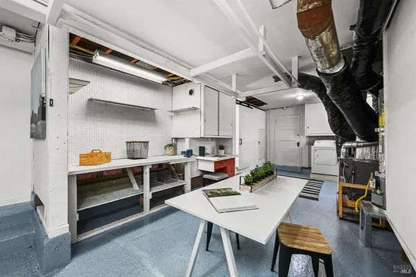 a view of a patio with table and chairs potted plants and large tree