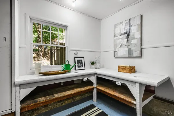 a view of a patio with table and chairs with wooden floor and fence