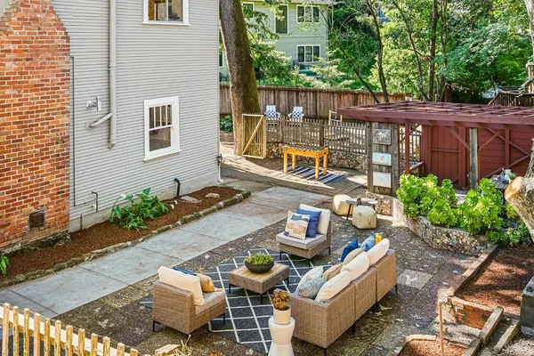 a view of a chairs and table in the backyard