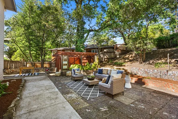 a view of a house with backyard and sitting area