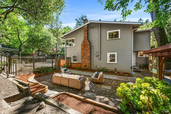 a view of a backyard with sitting area