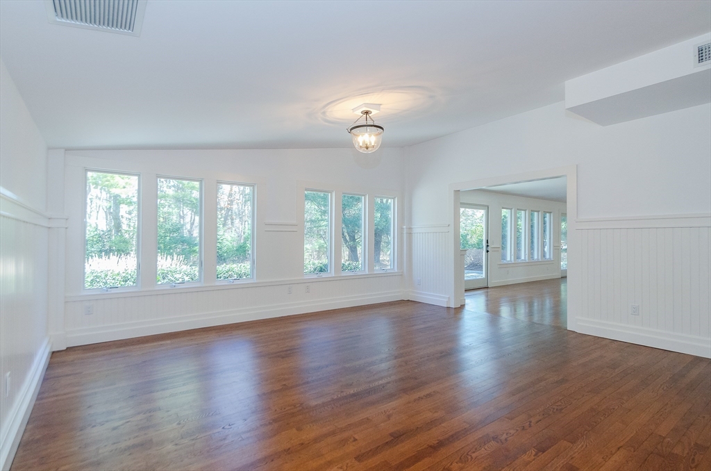 345 Point Road Marion, MA 02738 - Photo 15 of 41 an empty room with wooden floor and windows