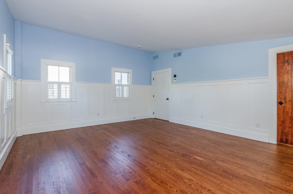 345 Point Road Marion, MA 02738 - Photo 20 of 41 an empty room with wooden floor and windows