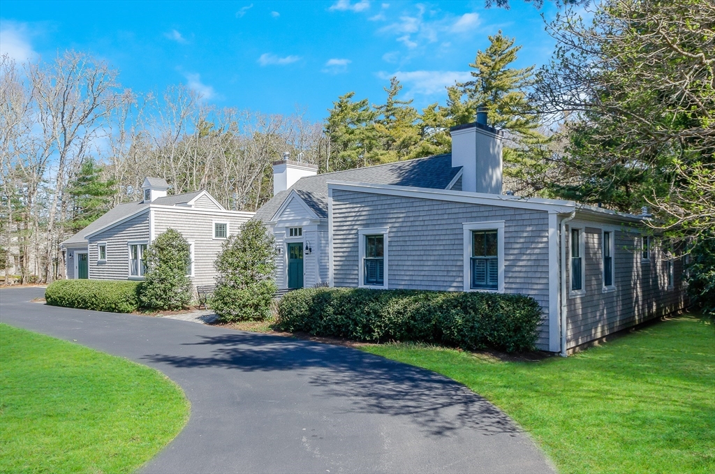 345 Point Road Marion, MA 02738 - Photo 2 of 41 a front view of a house with a yard and potted plants