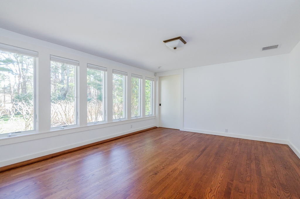 345 Point Road Marion, MA 02738 - Photo 31 of 41 an empty room with wooden floor and windows