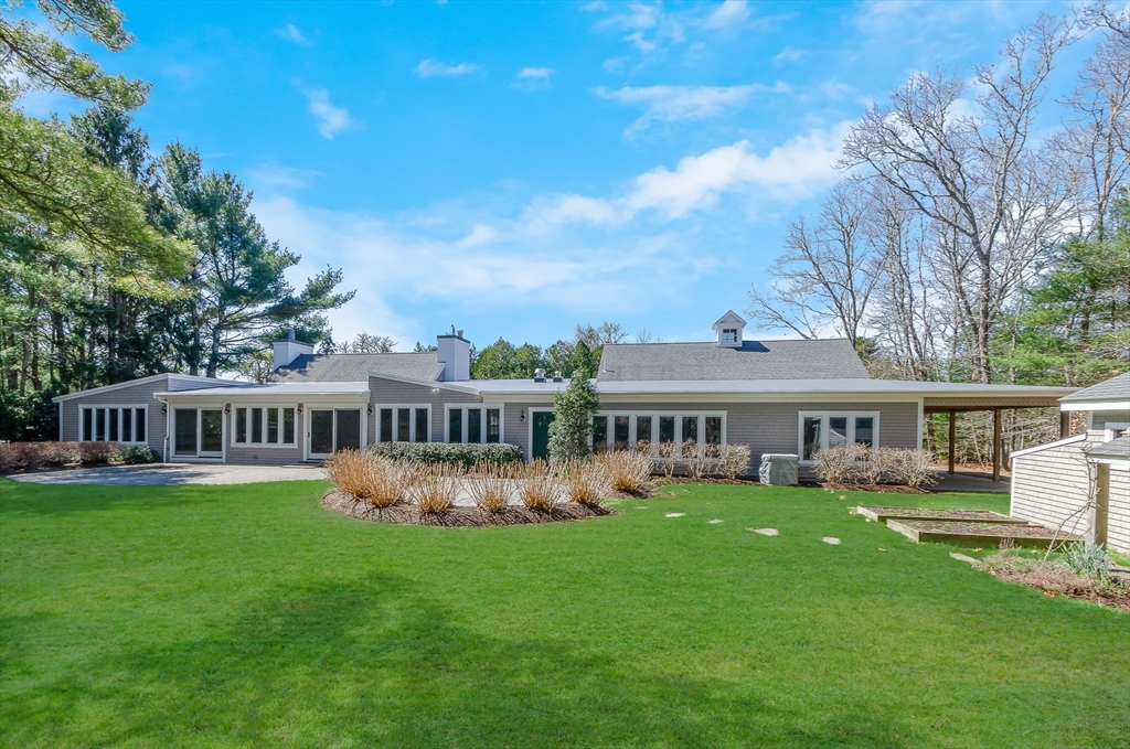 345 Point Road Marion, MA 02738 - Photo 37 of 41 a view of a house with a garden and trees