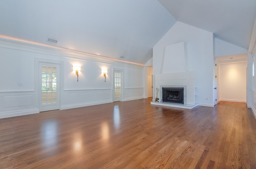 345 Point Road Marion, MA 02738 - Photo 5 of 41 an empty room with wooden floor fireplace and windows