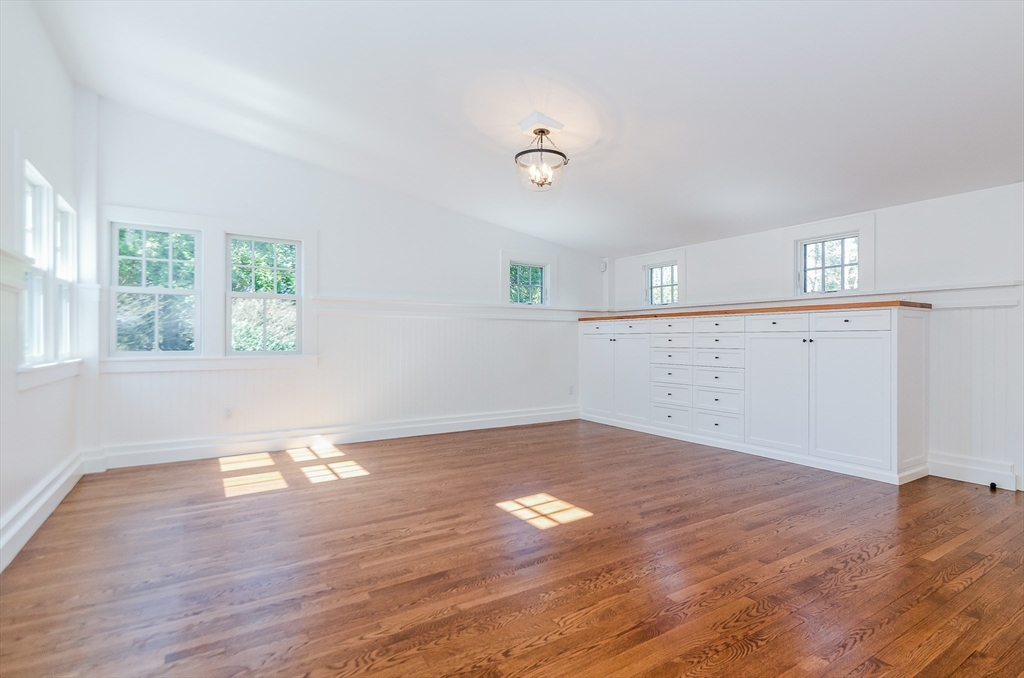 345 Point Road Marion, MA 02738 - Photo 9 of 41 an empty room with wooden floor and windows