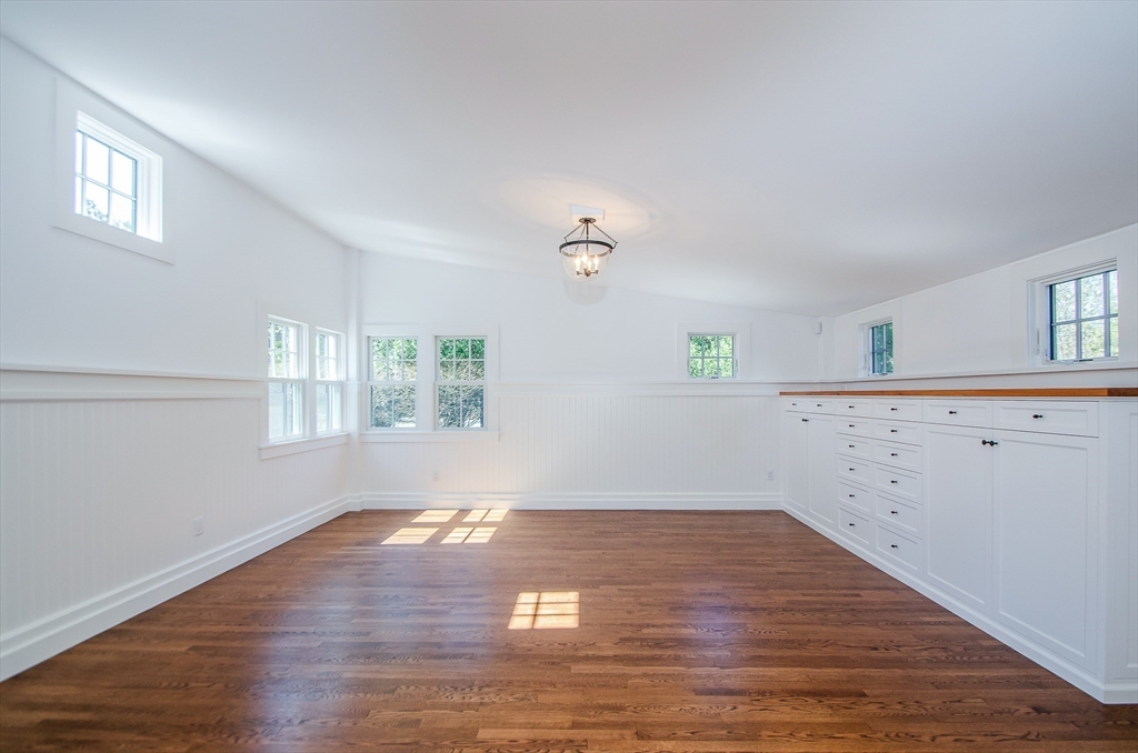 345 Point Road Marion, MA 02738 - Photo 10 of 41 an empty room with wooden floor and windows