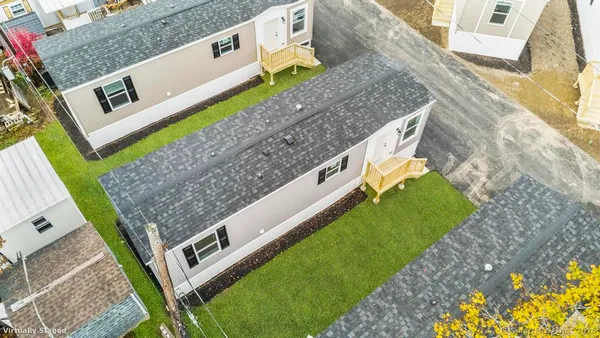 a view of a house with a backyard
