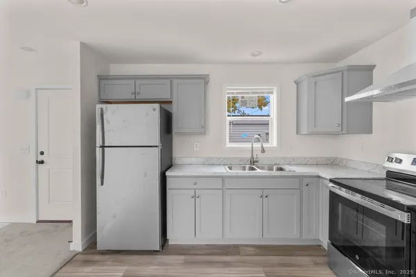 a kitchen with a sink a refrigerator and a stove