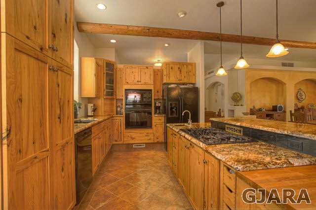 1701 10 Road Mack, CO 81525 - Photo 3 of 25 a bathroom with a granite countertop sink a large mirror and a shower