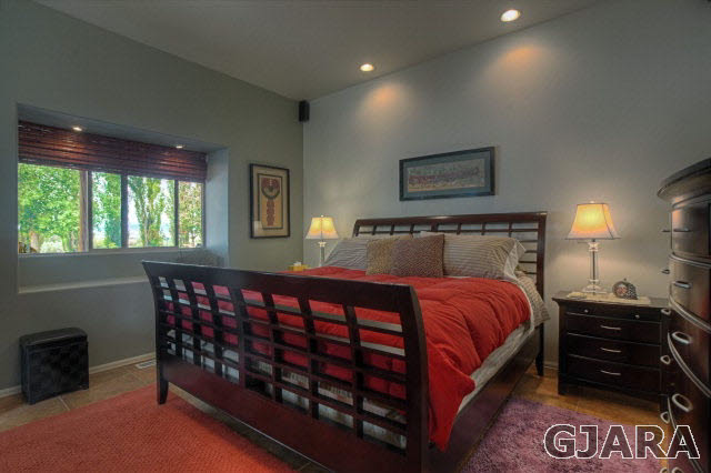 1701 10 Road Mack, CO 81525 - Photo 6 of 25 a bed sitting in a bedroom next to a window