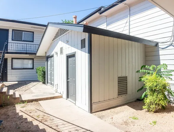 a view of a house with a window and flower in front of door
