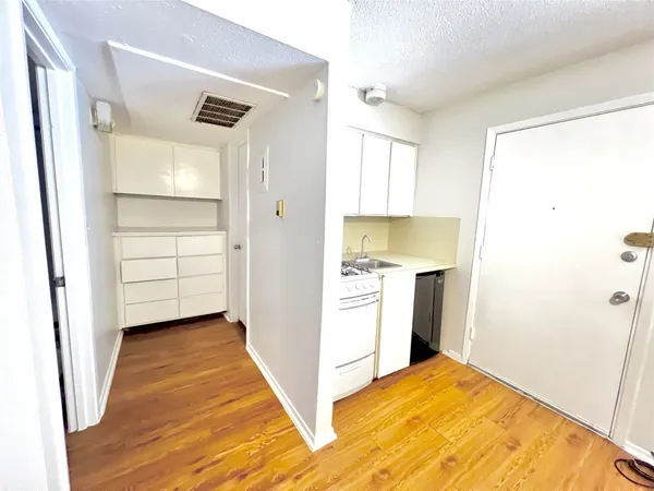 a view of a kitchen with storage and utility