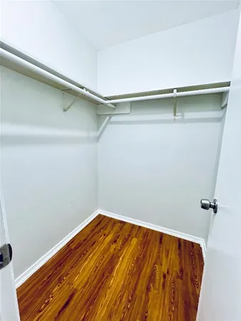 a view of a room with wooden floor and fan