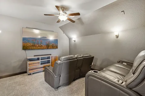 a living room with furniture and a ceiling fan