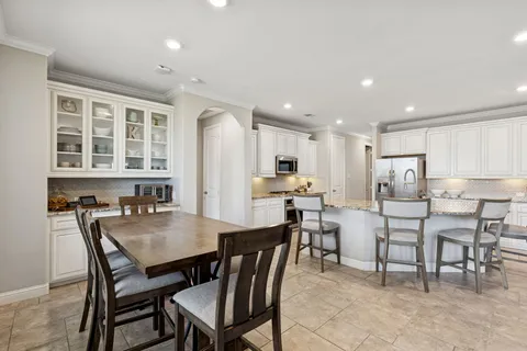 a bedroom with a large bed and a chandelier fan