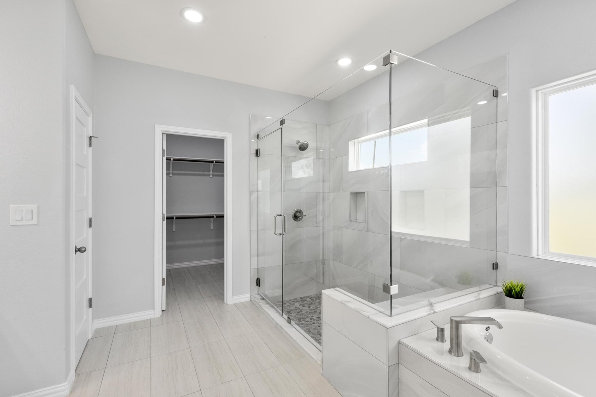 1136 County Road 484 Elgin, TX 78621 - Photo 19 of 37 Bathroom featuring a bath, a walk in closet, a stall shower, light tile patterned flooring, and recessed lighting