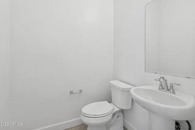 a bathroom with a sink toilet and a mirror