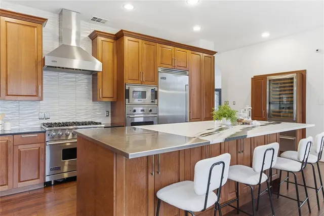 a kitchen with a stove a sink and a refrigerator