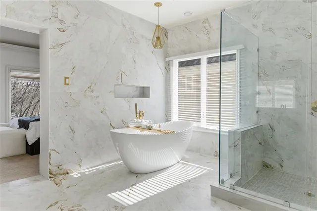 a bathroom with a bathtub and shower