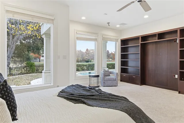 a bedroom with a bed and a large window