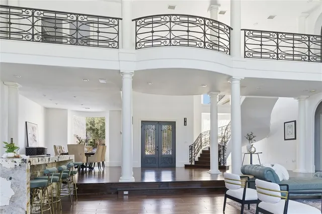 a view of hall way with furniture and wooden floor