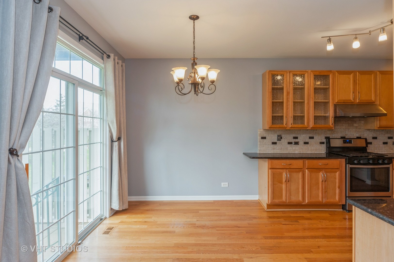 360 Bay Tree Circle Vernon Hills, IL 60061 - Photo 7 of 18 a view of a kitchen with granite countertop a stove top oven a sink with wooden floor and cabinets