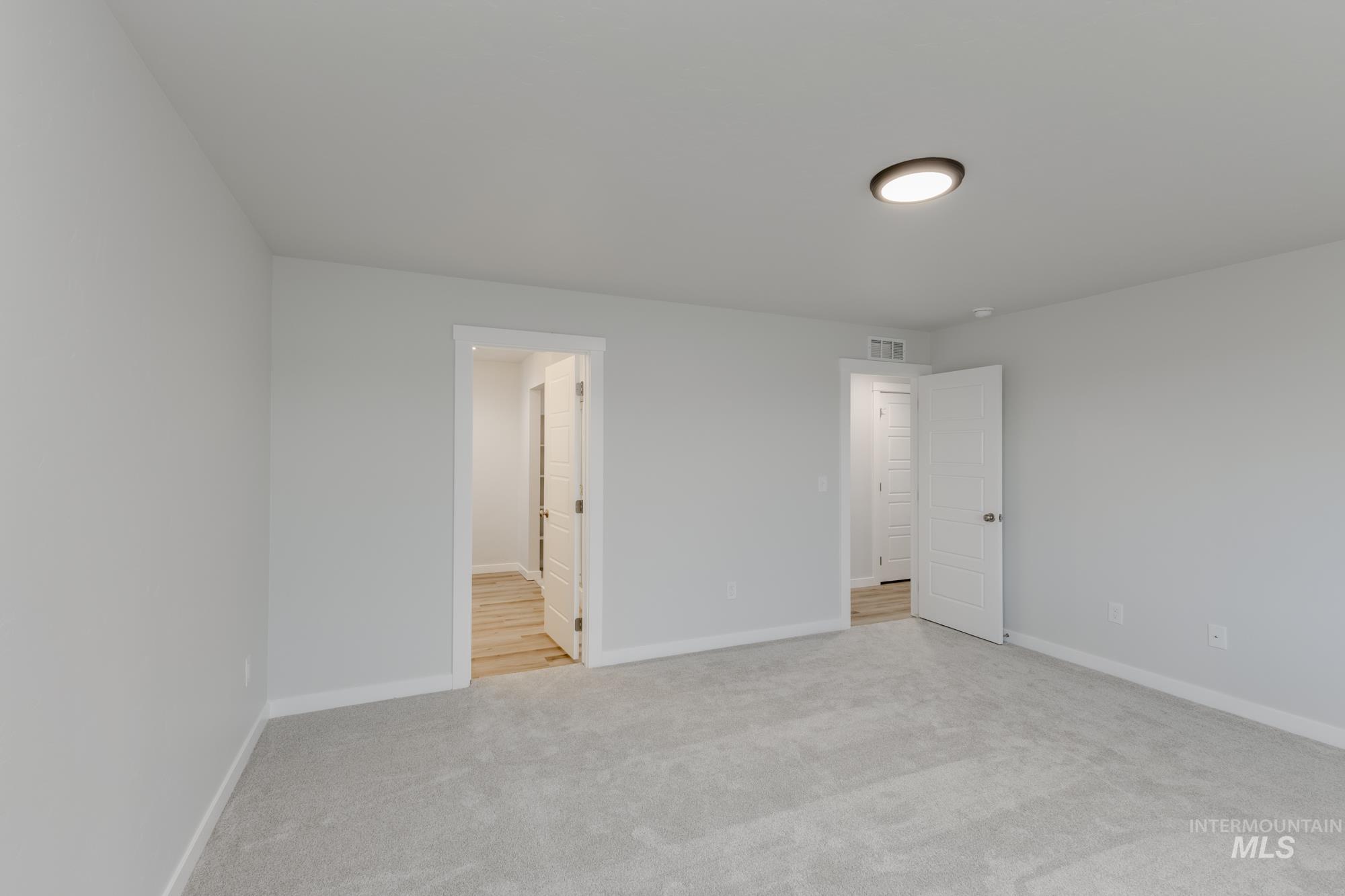 16697 Carlin Avenue Caldwell, ID 83607 - Photo 16 of 18 Unfurnished bedroom featuring light colored carpet and baseboards