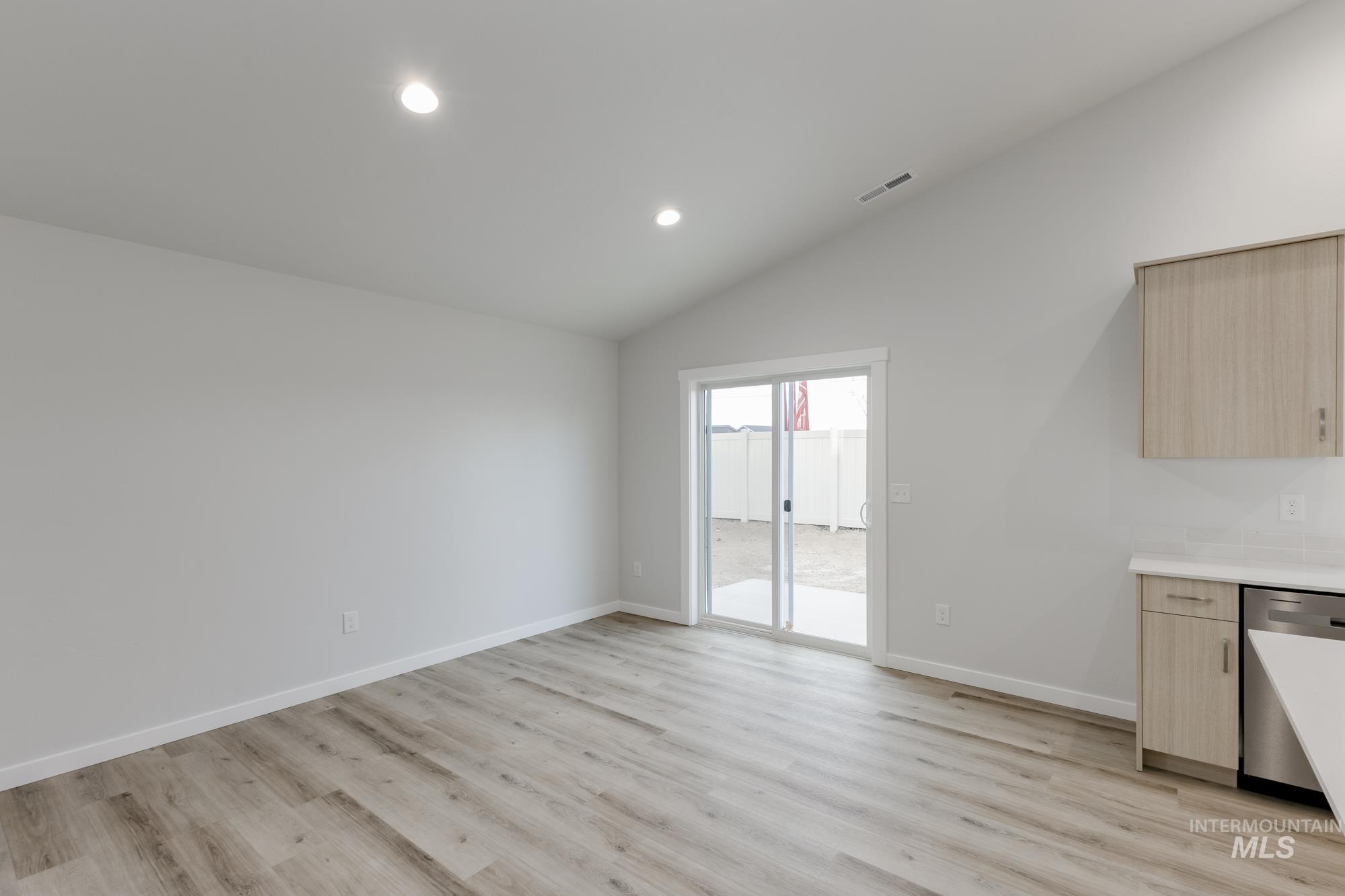 16697 Carlin Avenue Caldwell, ID 83607 - Photo 6 of 18 Unfurnished dining area featuring light wood-style floors, recessed lighting, and lofted ceiling