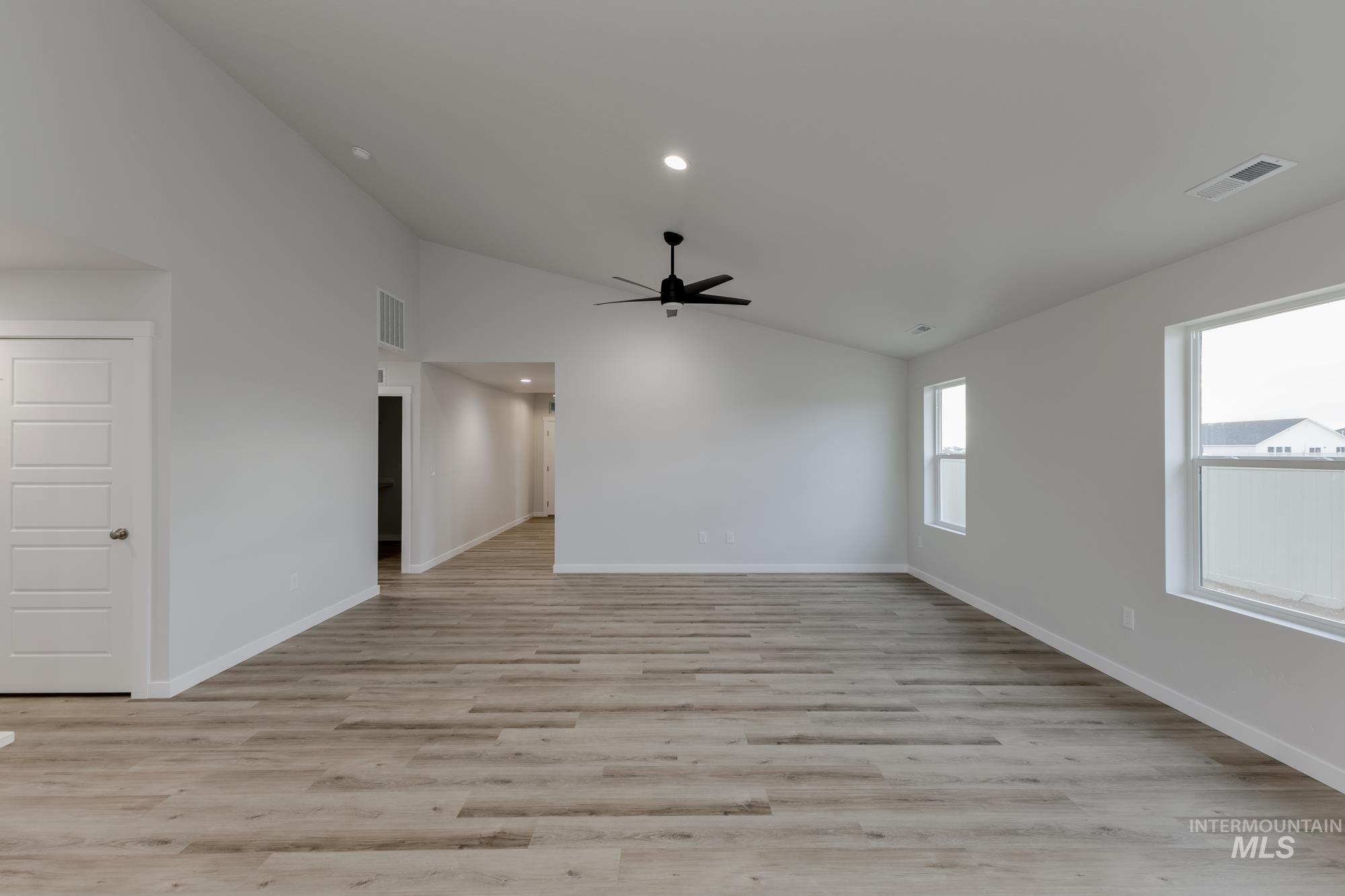 16697 Carlin Avenue Caldwell, ID 83607 - Photo 8 of 18 Spare room with light wood finished floors, a ceiling fan, recessed lighting, and high vaulted ceiling