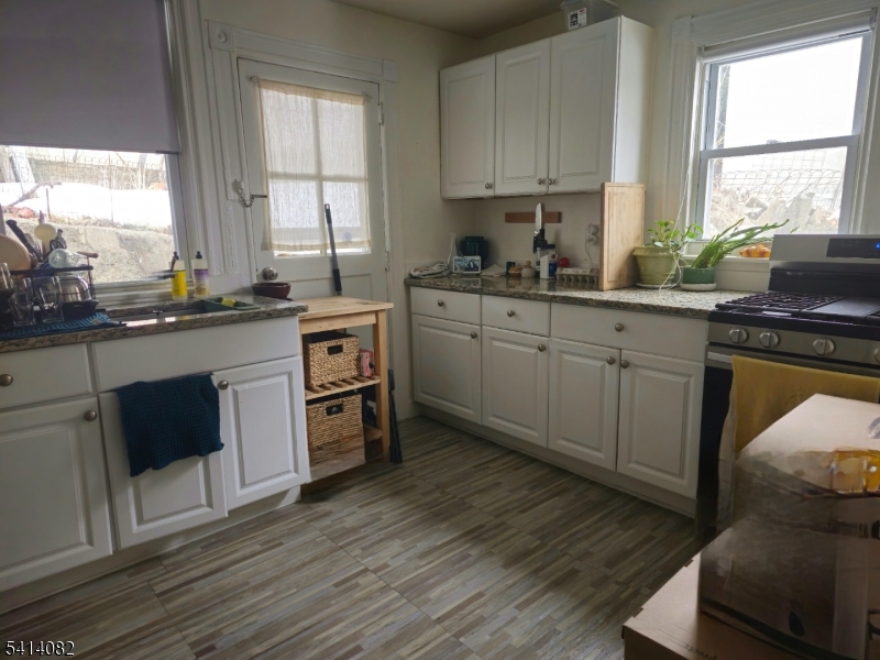 149 Broad Street Summit, NJ 07901 - Photo 10 of 12 a kitchen with a sink white cabinets and white appliances