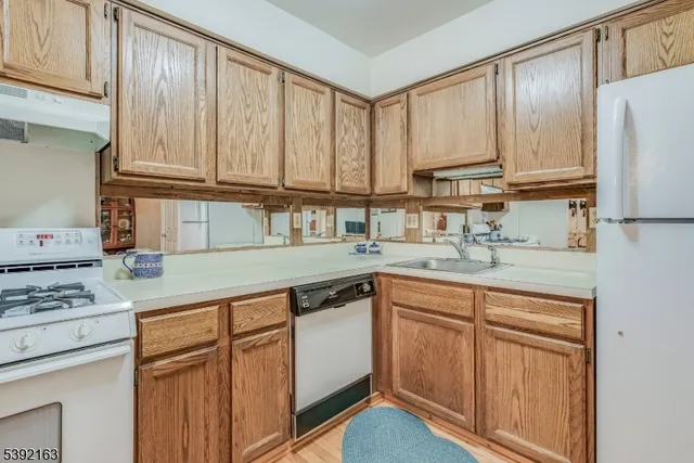 a kitchen with stainless steel appliances granite countertop a refrigerator sink and cabinets