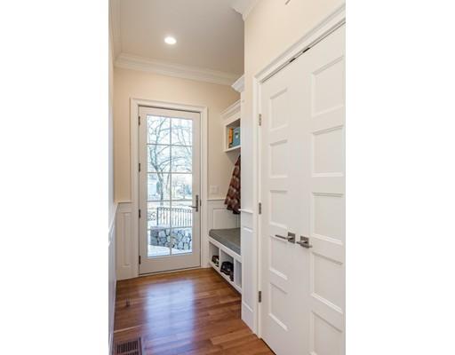 82 Broken Tree Road Newton, MA 02459 - Photo 8 of 28 a view of a hallway with wooden floor and a bathroom