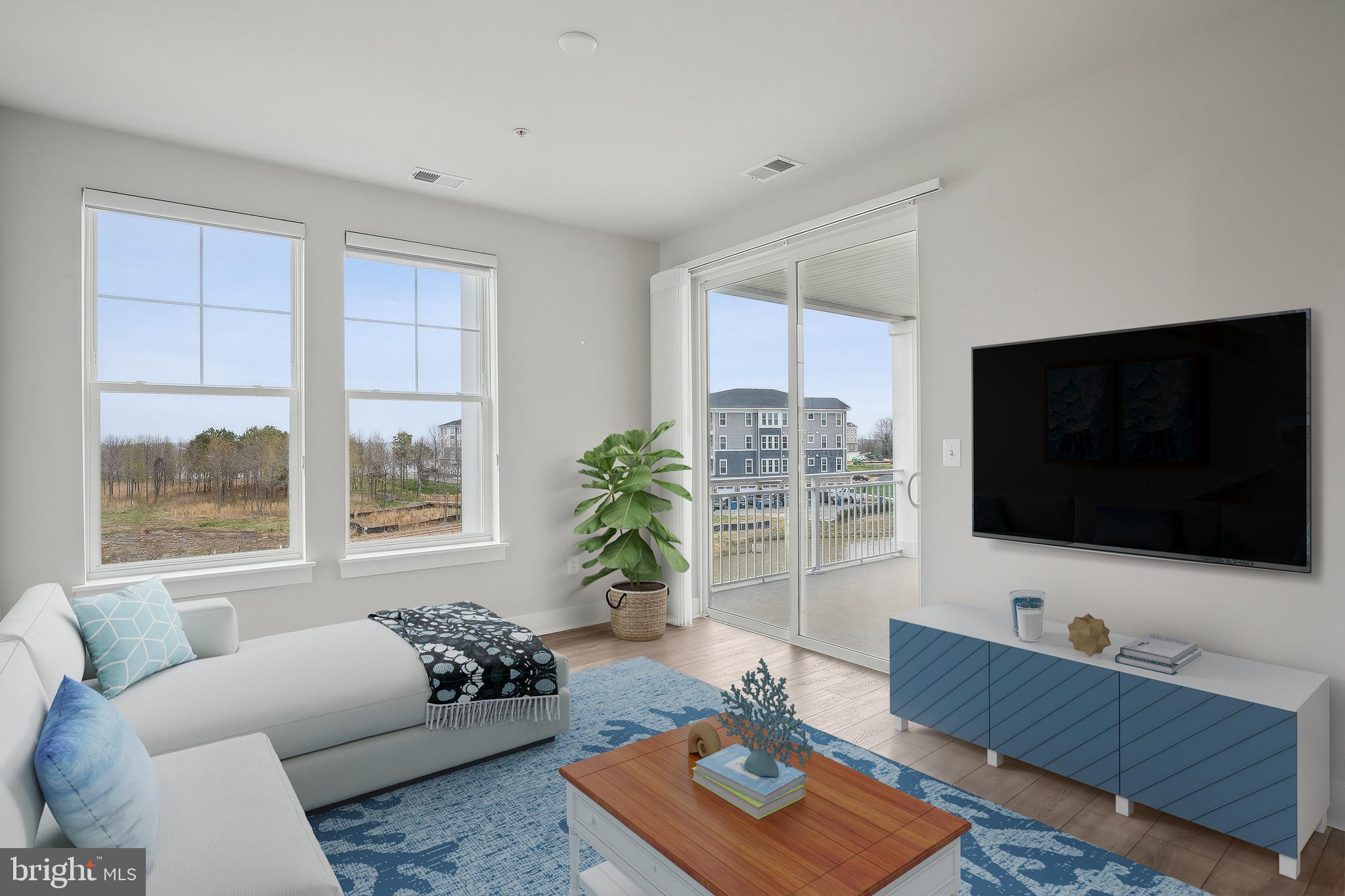 170 Harrier Way, Unit 34 Chester, MD 21619 - Photo 17 of 81 a living room with furniture and a flat screen tv